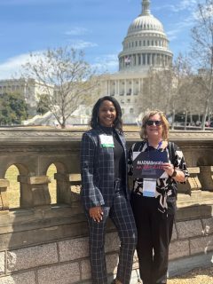 Two women standing in front of US Capital